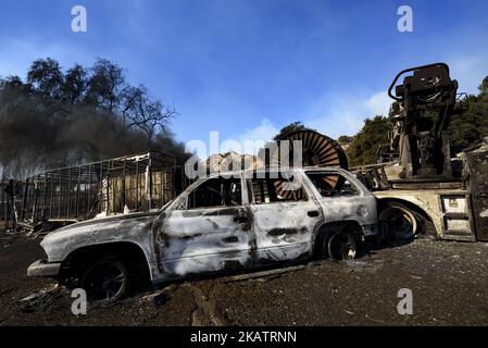 A car destroyed by the Creek Fire in the Sylmar neighborhood in Los Angeles, California, on December 6, 2017. The raging fire fueled by strong Santa Ana winds has burned more than 15,000 acres and caused the evacuation of 150,000 residents. (Photo by Ronen Tivony/NurPhoto) Stock Photo