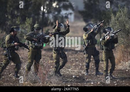 Israeli soldiers fire tear gas towards Palestinian protesters during a demonstration against U.S. President Donald Trump's recognition of Jerusalem as Israel's capital, in the West Bank city of Tulkarem, on 11 December 2017. (Photo by Ahmad Talat/NurPhoto) Stock Photo