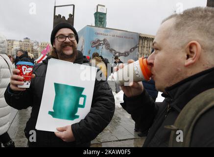 People drink coffee and participate at a rally called 'Coffee on the Khreshchatyk', as they protest against protests of Mikheil Saakashvili's supporters, on Independence Square in Kiev, Ukraine, 24 December, 2017 (Photo by STR/NurPhoto) Stock Photo
