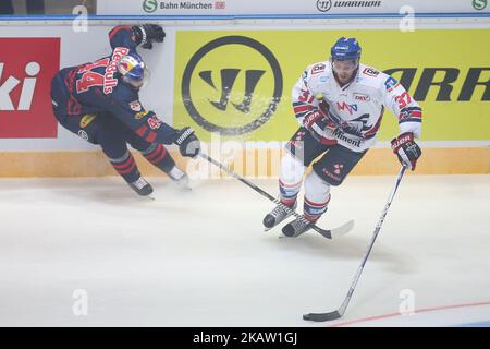 Markus Lauridsen of Red Bull Munich vies Thomas Larkin of Adler Mannheim during the 38th game day of the German Ice Hockey League between Red Bull Munich and Adler Mannheim in the Olympiahalle in Munich, Germany, on January 02, 2018. (Photo by Marcel Engelbrecht/NurPhoto) Stock Photo