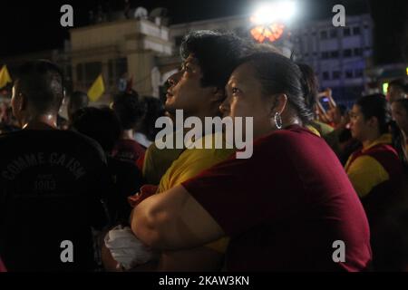 Devotees pray after the image of the Black Nazarene was successfully brought back inside the Quiapo Church in Manila, early morning of 10 January 2017. The feast of the Black Nazarene is held every 9th of January that attracts a massive crowd of mostly barefoot attendees as part of their sacrifice. The procession this year took 22 hours to finish. (Photo by George Calvelo/NurPhoto) Stock Photo