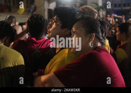 Devotees pray after the image of the Black Nazarene was successfully brought back inside the Quiapo Church in Manila, early morning of 10 January 2017. The feast of the Black Nazarene is held every 9th of January that attracts a massive crowd of mostly barefoot attendees as part of their sacrifice. The procession this year took 22 hours to finish. (Photo by George Calvelo/NurPhoto) Stock Photo