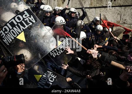 Protesters clash with police after the end of a protest against new reforms planned by the government concerning property auctions and labor strikes, outside parliament, in central Athens, Greece, 12 January 2018 Thousands of Greek protesters marched in central Athens on Friday against new reforms, including restrictions on the right to strike, that Parliament is set to approve next week in return for bailout funds. “Hands off strikes!” protesters with Communist-affiliated group PAME chanted during a march of about 20,000 people, as lawmakers debated in parliament. Others held banners reading  Stock Photo