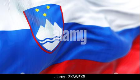 Close-up view of Slovenia national flag waving. The Republic of Slovenia is a sovereign state of Central Europe. Fabric textured background. Selective Stock Photo
