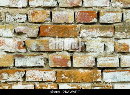 The old brick wall sagged and collapsed from the weather Stock Photo