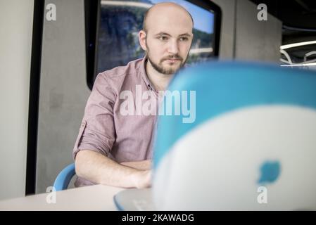 A member of staff shows iBook G3, release date May 2001, at MacPaw's Ukrainian Apple Museum in Kiev, Ukraine on January 26, 2017. Ukrainian developer MacPaw has opened Apple hardware museum at the company’s office in Kiev. The collection has more than 70 original Macintosh models dated from 1981 to 2017. (Photo by Oleksandr Rupeta/NurPhoto) Stock Photo