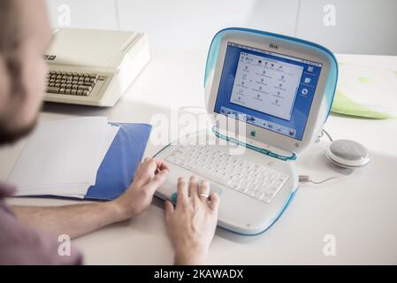 A member of staff shows iBook G3, release date May 2001, with Apple IIe, release date January 1983, on the background, at MacPaw's Ukrainian Apple Museum in Kiev, Ukraine on January 26, 2017. Ukrainian developer MacPaw has opened Apple hardware museum at the company’s office in Kiev. The collection has more than 70 original Macintosh models dated from 1981 to 2017. (Photo by Oleksandr Rupeta/NurPhoto) Stock Photo