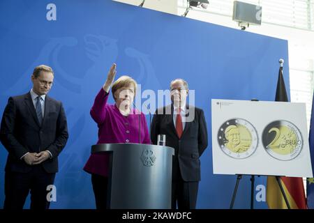 (L-R) Berlin's Mayor Michael Mueller, German Chancellor Angela Merkel and former German Finance Minister Peer Steinbrueck are pictured during the presentation of new 2 Euro coins with images of Berlin and of former Chancellor Helmut Schmidt at the Chancellery in Berlin, Germany on February 2, 2018. (Photo by Emmanuele Contini/NurPhoto) Stock Photo