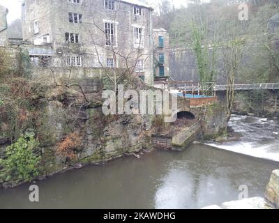 The Torr Vale Mill with the Goyt river in the foreground in Torrs Riverside Park, New Mills Stock Photo