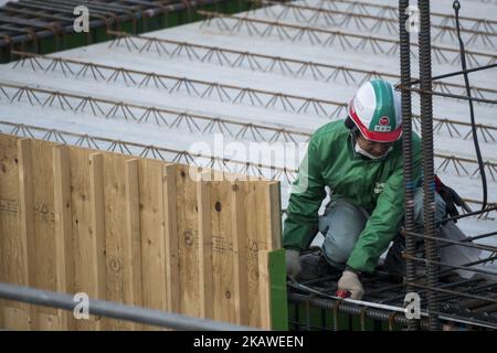 Men work at the construction site for the Tokyo 2020 venue 'Ariake Arena' in Tokyo on February 6, 2018. The new facility will host volleyball during the 2020 Tokyo Olympic Games. And also the Paralympic Games will hold wheelchair basketball. Tokyo Metropolitan Government (TMG) 'Tokyo 2020 Venues Media Tour' to explain updated progress of the constructions. (Photo by Alessandro Di Ciommo/NurPhoto) Stock Photo