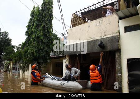 The joint rescue officers from the fire department, police and Jakarta Regional Disaster Mitigation Agency, evacuated residents as floods hit several areas in Jakarta on Tuesday, February 6, 2018. Heavy rains that occurred over the past few days, caused a number of areas in the capital flooded with high altitude water ranges from 50-200 cm. (Photo by Aditya Irawan/NurPhoto) Stock Photo