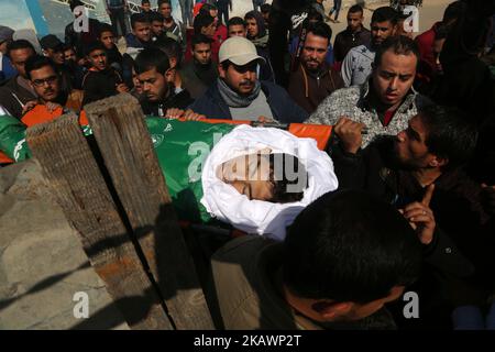 (EDITORS NOTE: Image contains graphic content) Mourners carry the body of Palestinian Ahmad Abu Al-Helo, 19, during his funeral in Al Bureij refugee camp in the central Gaza strip February 21, 2018. (Photo by Majdi Fathi/NurPhoto) Stock Photo