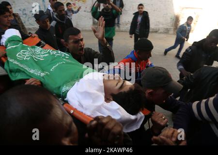 (EDITORS NOTE: Image contains graphic content) Mourners carry the body of Palestinian Ahmad Abu Al-Helo, 19, during his funeral in Al Bureij refugee camp in the central Gaza strip February 21, 2018. (Photo by Majdi Fathi/NurPhoto) Stock Photo