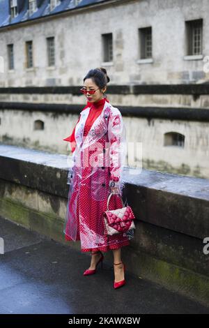 Aimee Song poses wearing a Burberry trench coat and Valentino dress and bag after the Valentino show at Les Invalides during Paris Fashion Week Womenswear FW 18/19 on March 4, 2018 in Paris, France. (Photo by Nataliya Petrova/NurPhoto)