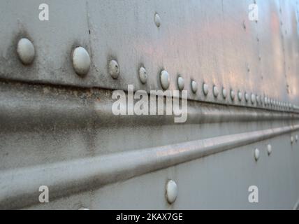 A closeup shot of a steel surface with rivets on it Stock Photo