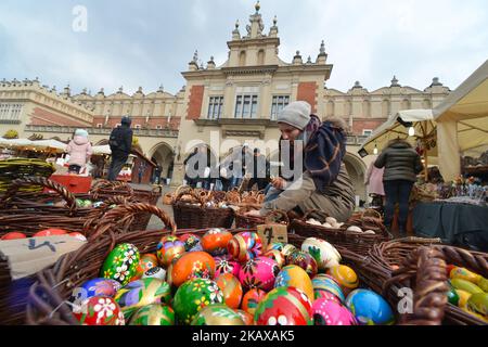 Hand made traditional hand painted Easter eggs (Polish: Pisanki) and baskets on display for sale on Krakow's Easter market. Originating as a pagan tradition, pisanki were absorbed by Christianity to become the traditional Easter egg. Pisanki are now considered to symbolise the revival of nature and the hope that Christians gain from faith in the resurrection of Jesus Christ. On Tuesday, 27 March 2018, in Rynek Square, Krakow, Poland. (Photo by Artur Widak/NurPhoto) Stock Photo