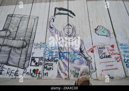 Political and social mural paintings and graffitis on the Israeli West Bank barrier in Bethlehem, West Bank on March 13, 2018. (Photo by Artur Widak/NurPhoto) Stock Photo