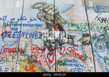 Political and social mural paintings and graffitis on the Israeli West Bank barrier in Bethlehem, West Bank on March 13, 2018. (Photo by Artur Widak/NurPhoto) Stock Photo