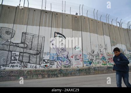Political and social mural paintings and graffitis on the Israeli West Bank barrier in Bethlehem, West Bank on March 13, 2018. (Photo by Artur Widak/NurPhoto) Stock Photo