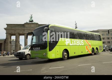 A Flixbus bus drives in front of Brandenburg Gate in Berlin, Germany on April 4, 2018. After starting its services in 2013 in Germany, the company has become active in 27 European countries and leader in the market, bulding up a network of about 300 middle-sized partner transportation companies. Flixbus plans expand into the US market starting this year and it's developing with a Chinese company E-Buses for long destination travels. (Photo by Emmanuele Contini/NurPhoto) Stock Photo