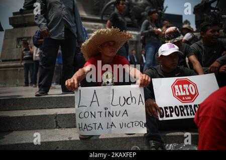 A Central American migrant, part of the the annual Stations of the Cross caravan march for migrants' rights, holds a sign that reads in Spanish 'the fight continues (L) and stop the deportations' (R) during a protest at the Angel of Independence monument in Mexico City, Saturday, April 7, 2018. Mexico's capital is the final planned stop of the migrant caravan that left from the Mexico-Guatemala border late last month to draw attention to policies toward immigrants and refugees. (Photo by Emilio Espejel/NurPhoto) Stock Photo