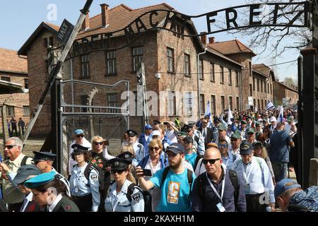 March of The Living participants with Israeli (Israel) flags are seen in Auschwitz I Death Camp in Oswiecim, Poland on 12 April 2018 Taking place annually on Yom Hashoah - Holocaust Remembrance Day - The March of the Living itself is a 3-kilometer walk from Auschwitz to Birkenau as a tribute to all victims of the Holocaust. (Photo by Michal Fludra/NurPhoto) Stock Photo