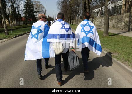 March of The Living participants with Israeli (Israel) flags are seen in Auschwitz I Death Camp in Oswiecim, Poland on 12 April 2018 Taking place annually on Yom Hashoah - Holocaust Remembrance Day - The March of the Living itself is a 3-kilometer walk from Auschwitz to Birkenau as a tribute to all victims of the Holocaust. (Photo by Michal Fludra/NurPhoto) Stock Photo