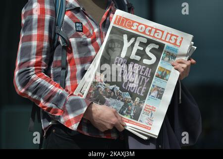 An activist holds 'The Socialist' newspaper with 'Yes for Repeal Equality Choice' written on the front page, during a Rally for Equality, Freedom & Choice organised by ROSA - an Irish Socialist Feminist Movement at Liberty Hall in Dublin, Ireland on April 14, 2018. (Photo by Artur Widak/NurPhoto) Stock Photo