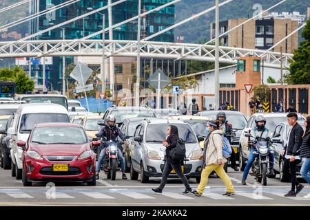 Bogota Colombia,El Chico Carrera 11,man men male woman women female line queue waiting cars vehicles motorcycles intersection stopped traffic crossing Stock Photo