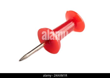 Macro shot of a red pushpin isolated on a white background. Stationery, copy space. Stock Photo