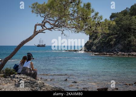 Tourists watch old-fashioned pirate ships navigate the Mediterranean Sea in Phaselis, Antalya, a historic tourism attraction in southern Turkey on 22 April 2018. (Photo by Diego Cupolo/NurPhoto) Stock Photo