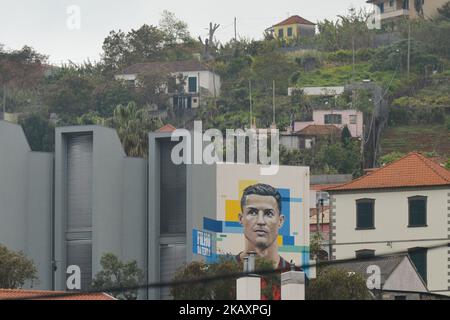 A general view of a part of Santo Antonio (English: Saint Anthony) with Cristiano Ronaldo mural 'Son of the Land' seen on a shopping center wall. Portuguese football star Cristiano Ronaldo grew up here and played for amateur team Andorinha from 1992 to 1995. On Thursday, April 26, 2018, in Funchal, Madeira Island, Portugal. (Photo by Artur Widak/NurPhoto)  Stock Photo