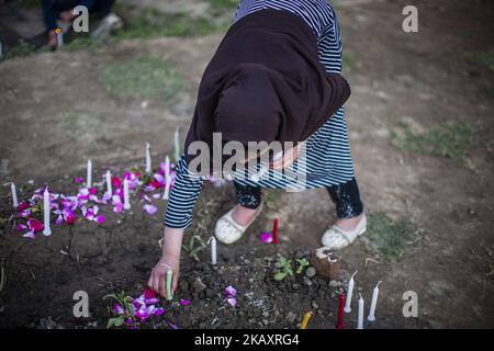 Kashmiri Shiite Muslims pray as they light candles at a graveyard to mark Shab-e- Barat on May 1, 2018 in Srinagar, the summer capital of Indian administered Kashmir, India. Shab-e-Barat, one of the holiest nights in the Islamic calendar, is marked by Muslims visiting graves of family members and relatives to pray for the deceased. Night long prayers are held in mosques. (Photo by Kabli Yawar/NurPhoto) (Photo by Yawar Nazir/NurPhoto) Stock Photo