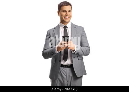 Young professional man in a gray suit using a smartphone and smiling isolated on white background Stock Photo