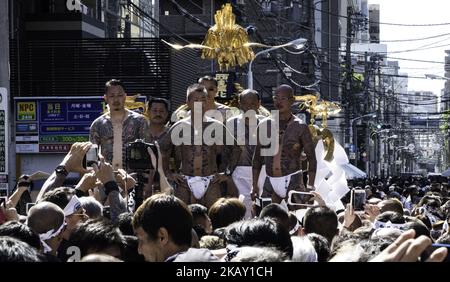 A heavily tattooed Japanese men stand on the mikoshi before carrying the portable shrine in the streets of Asakusa during Tokyo's one of the largest three day festival called 'Sanja Matsuri' on the third and final day, May 20, 2018 in Tokyo, Japan. A boisterous traditional mikoshi (portable shrine) is carried in the streets of Asakusa to bring luck, blessings and prosperity to the area and its inhabitants. (Photo by Richard Atrero de Guzman/NurPhoto) Stock Photo