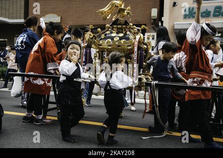 Japanese children wearing 'happi' coats relax during break time just after carrying the portable shrine in Tokyo's one of the largest three day festival called 'Sanja Matsuri' on it's second day, May 19, 2018 in Tokyo, Japan. A boisterous traditional mikoshi (portable shrine) is carried in the streets of Asakusa to bring luck, blessings and prosperity to the area and its inhabitants. (Photo: Richard Atrero de Guzman/Nur Photo) (Photo by Richard Atrero de Guzman/NurPhoto) Stock Photo