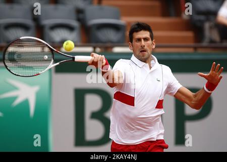 Novak Djokovic of Serbia plays a backhand during the mens singles first round match against Rogerio Dutra Silva of Brazil during day two of the 2018 French Open at Roland Garros on May 28, 2018 in Paris, France. (Photo by Mehdi Taamallah/NurPhoto) Stock Photo