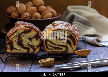 Traditional Easter bread with chocolate and nut filling on a wooden background. Stock Photo