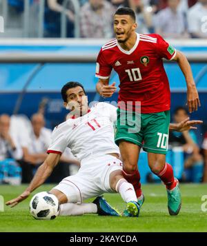 Younes Belhanda (R) of Morocco national team and Vahid Amiri of IR Iran national team vie for the ball during the 2018 FIFA World Cup Russia Group B match between Morocco and IR Iran on June 15, 2018 at Saint Petersburg Stadium in Saint Petersburg, Russia. (Photo by Mike Kireev/NurPhoto) Stock Photo