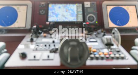 Navigational control panel and VHF radio. Working on the ship's navigational bridge. Blurred image. Stock Photo