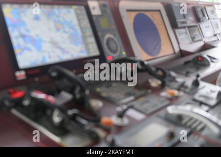 Navigational control panel and VHF radio. Working on the ship's navigational bridge. Blurred image. Stock Photo