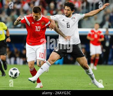Fedor Smolov (L) of Russia national team and Ahmed Hegazy of Egypt national team vie for the ball during the 2018 FIFA World Cup Russia group A match between Russia and Egypt on June 19, 2018 at Saint Petersburg Stadium in Saint Petersburg, Russia. (Photo by Mike Kireev/NurPhoto) Stock Photo