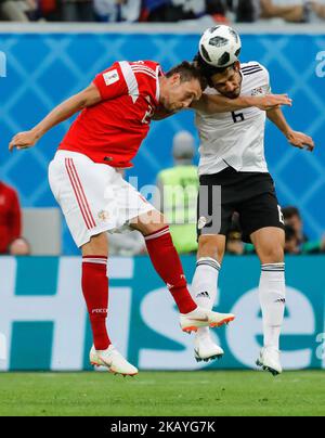 Artem Dzyuba (L) of Russia national team and Ahmed Hegazy of Egypt national team vie for a header during the 2018 FIFA World Cup Russia group A match between Russia and Egypt on June 19, 2018 at Saint Petersburg Stadium in Saint Petersburg, Russia. (Photo by Mike Kireev/NurPhoto) Stock Photo