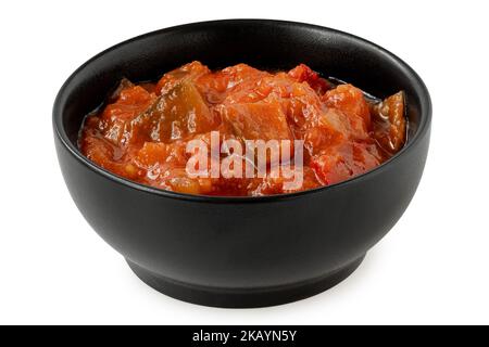 Ratatouille in black ceramic bowl isolated on white. Stock Photo