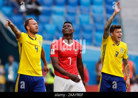Breel Embolo (C) of Switzerland national team looks on as Andreas Granqvist (L) and Victor Lindelof of Sweden national team react during the 2018 FIFA World Cup Russia Round of 16 match between Sweden and Switzerland on July 3, 2018 at Saint Petersburg Stadium in Saint Petersburg, Russia. (Photo by Mike Kireev/NurPhoto) Stock Photo