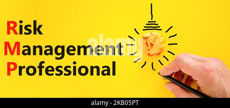 RMP risk management professional symbol. Concept words RMP risk management professional on a beautiful yellow background. Light bulb. Business RMP ris Stock Photo