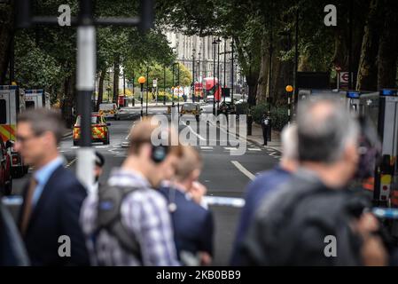 Police officers secure the roads around the Houses of Parliament as forensic teams continue their work around a vehicle after it crashed into security barriers, injuring a number of pedestrians, outside the Houses of Parliament on August 14, 2018 in London, England. A man has been arrested and it is currently unknown whether the crash was a deliberate act. (Photo by Alberto Pezzali/NurPhoto) Stock Photo