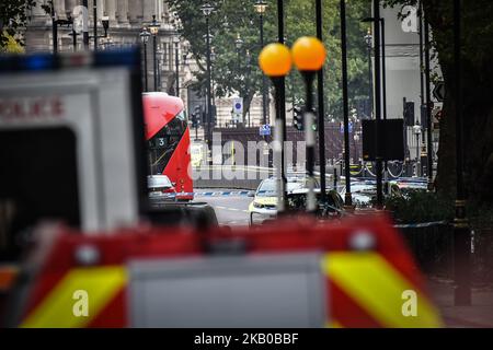 Police officers secure the roads around the Houses of Parliament as forensic teams continue their work around a vehicle after it crashed into security barriers, injuring a number of pedestrians, outside the Houses of Parliament on August 14, 2018 in London, England. A man has been arrested and it is currently unknown whether the crash was a deliberate act. (Photo by Alberto Pezzali/NurPhoto) Stock Photo