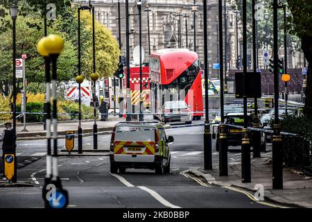 Police officers secure the roads around the Houses of Parliament as forensic teams continue their work around a vehicle after it crashed into security barriers, injuring a number of pedestrians, outside the Houses of Parliament on August 14, 2018 in London, England. A man has been arrested and it is currently unknown whether the crash was a deliberate act. (Photo by Alberto Pezzali/NurPhoto) Stock Photo