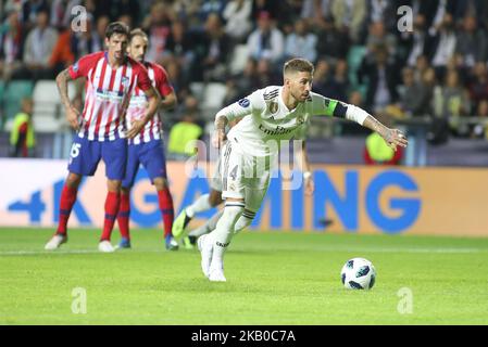 Real Madrid's Spanish defender Sergio Ramos (R) scores the 2-1 from the penalty spot against Atletico Madrid's Slovenian goalkeeper Jan Oblak (not in picture) during the UEFA Super Cup football match Atletico de Madrid vs Real Madrid CF at the Lillekula Stadium in Tallinn, Estonia, on August 15, 2018. (Photo by Ahmad Mora/NurPhoto) Stock Photo